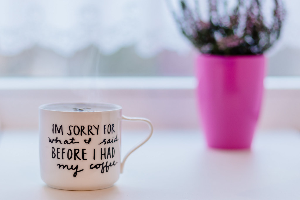 Xícara de café fumegante perto da janela em uma manhã calma